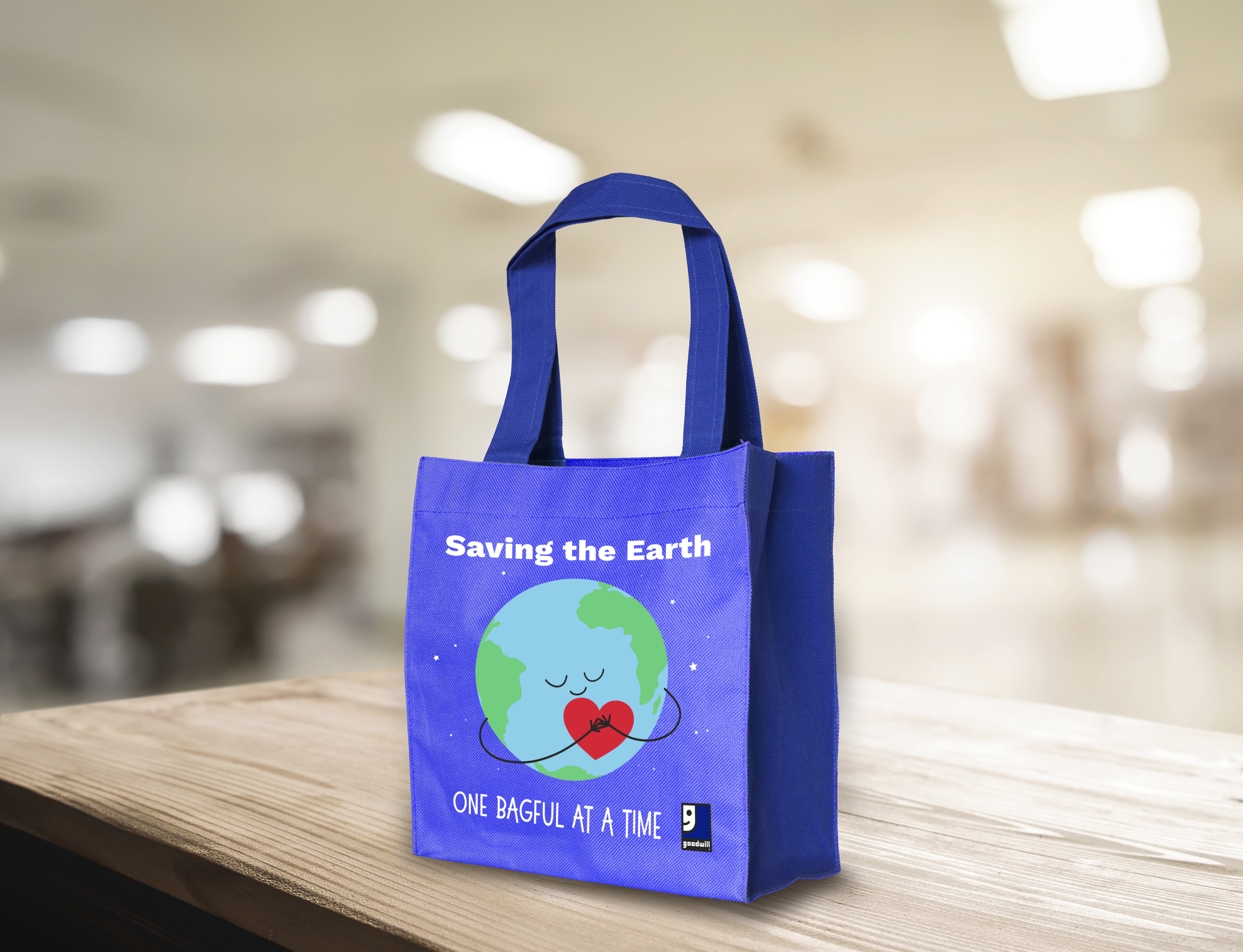 Goodwill reusable shopping bag with Saving the Earth One Bagful at a Time artwork.