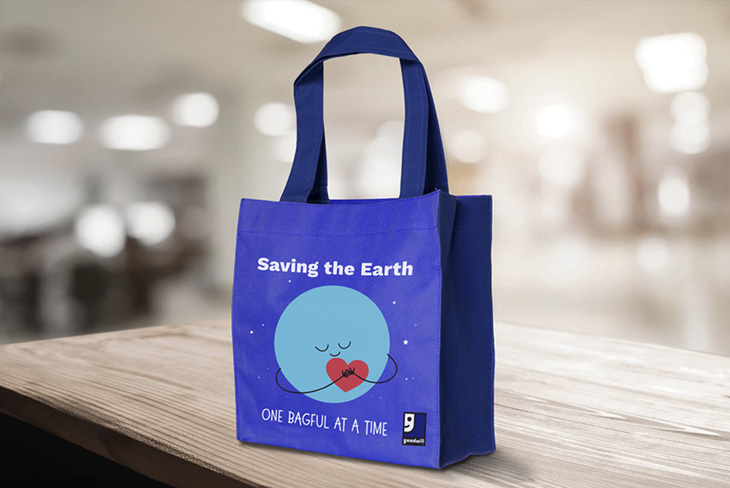 Reusable Goodwill shopping bag displayed in a retail setting.